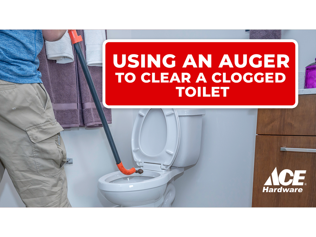 Using an auger to clear a clogged toilet