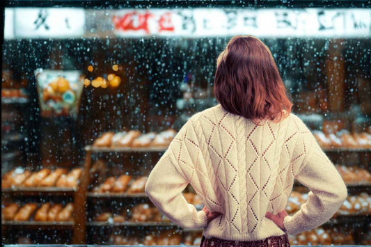 Woman looking out the window raining