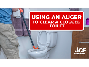 Using an auger to clear a clogged toilet