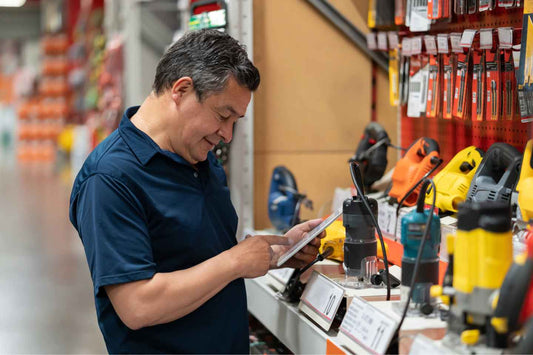 man looking at power tools